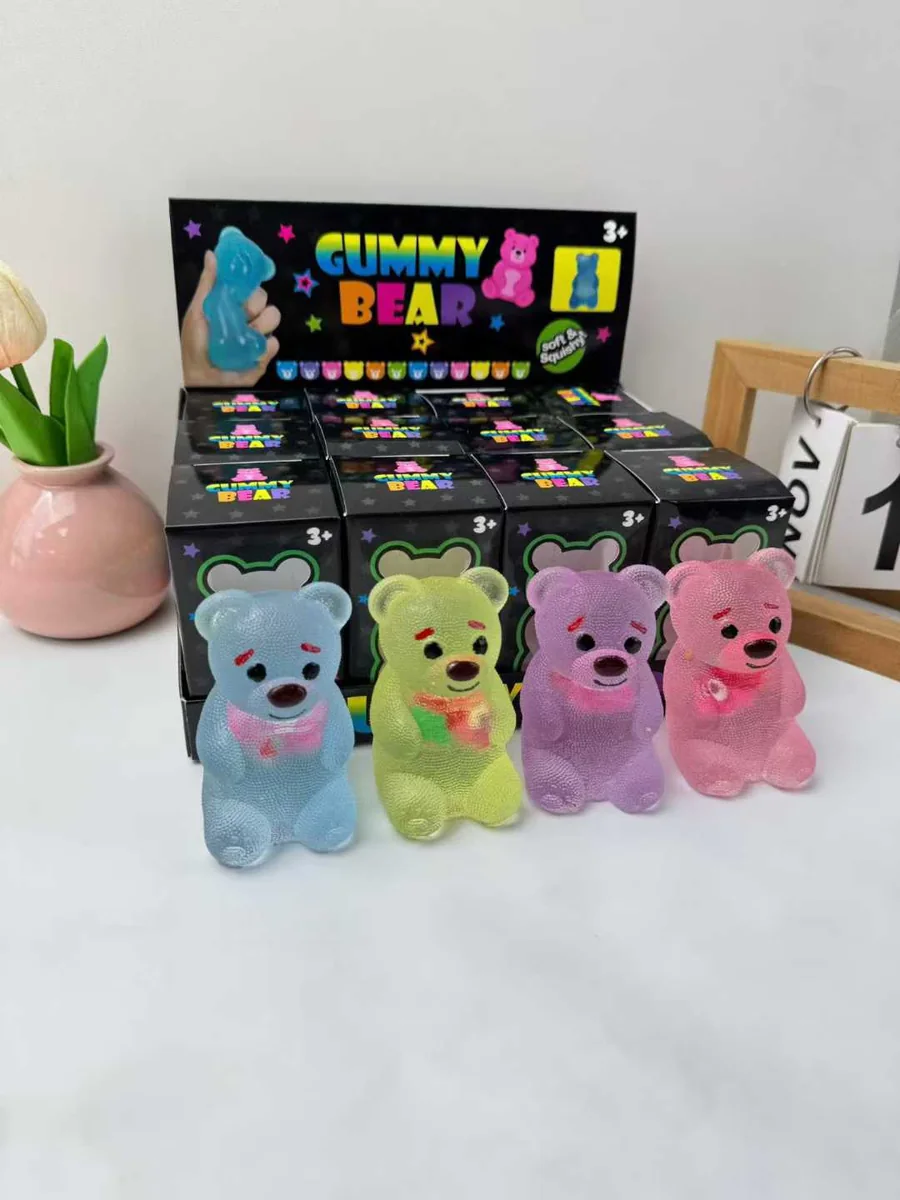 Gummy bear squishy toys shown with individual retail boxes and a display tray
